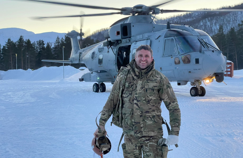 Ben Everitt MP in front of an army helicopter