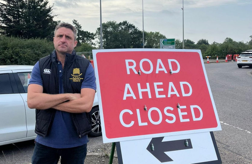 Ben Everitt MP at the closure sign for the A509