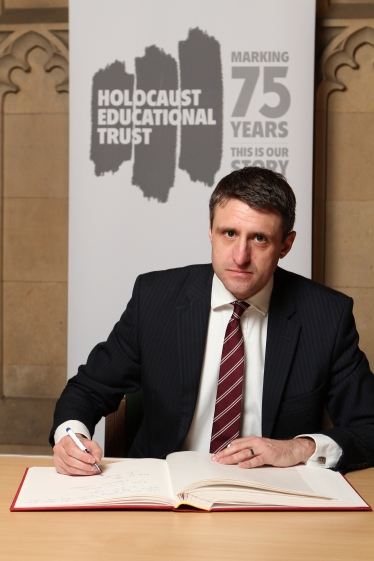 Ben Signing The Holocaust Educational Trust's Book Of Commitment