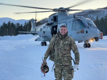 Ben Everitt MP in front of an army helicopter