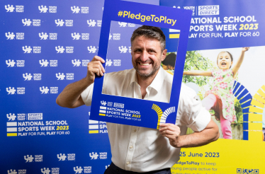 Ben Everitt MP with a National School Sports Week sign